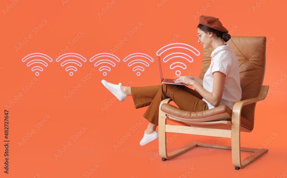 Young woman with laptop using wi-fi on color background Young woman with laptop using wi-fi on color background