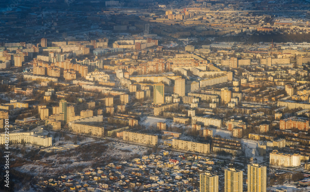 Aerial view of residential areas of a large northern city. Winter cityscape. Top view of multi-storey residential buildings and private houses on the outskirts of the city of St. Petersburg, Russia. Aerial view of residential areas of a large northern city. Winter cityscape. Top view of multi-storey residential buildings and private houses on the outskirts of the city of St. Petersburg, Russia.