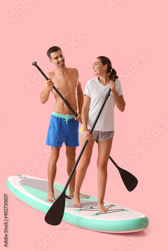 Young couple with board for...
