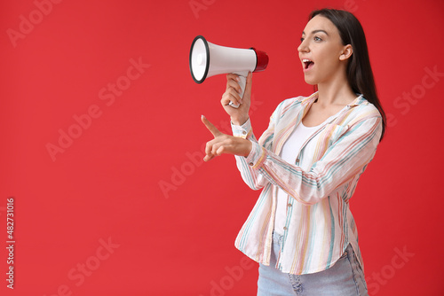 Young woman shouting into m...