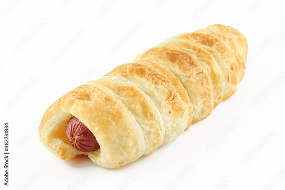 Hot dog stuffed pastry isolated on white background. Golden color dough