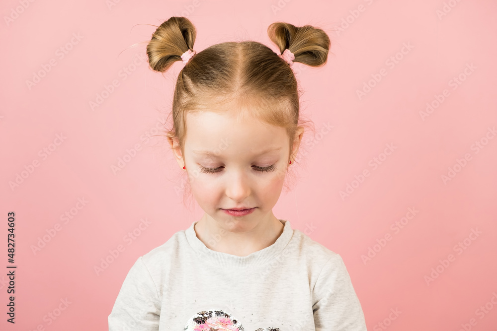 Sad little blonde girl on pink background. Valentines Day or Mothers Day concept Sad little blonde girl on pink background. Valentines Day or Mothers Day concept