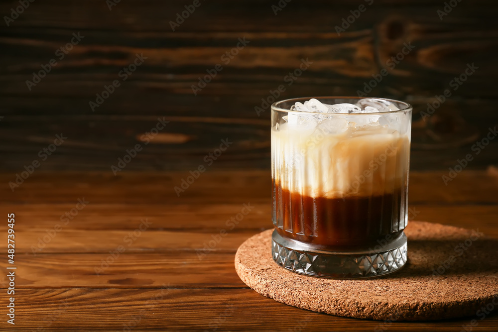 Glass of White Russian cocktail on wooden background Glass of White Russian cocktail on wooden background