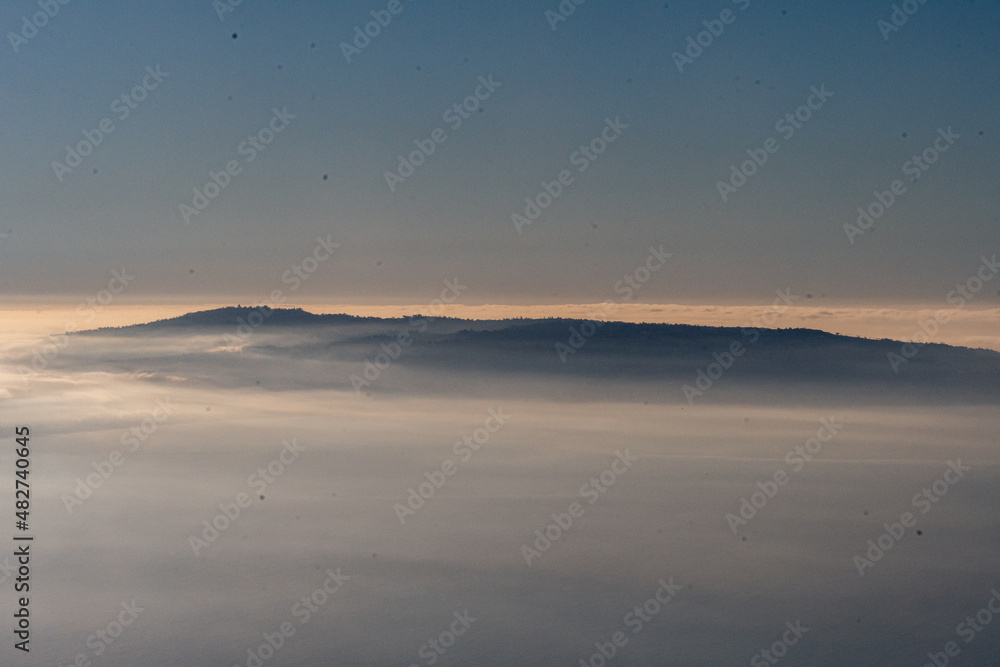 Headlands of the California coast rising up through fog.
Headlands of the California coast rising up through fog.