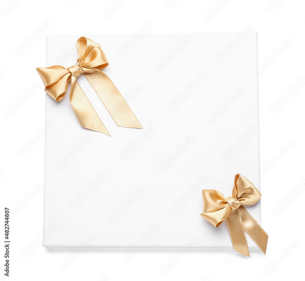 Blank board with golden ribbon bows on white background Blank board with golden ribbon bows on white background