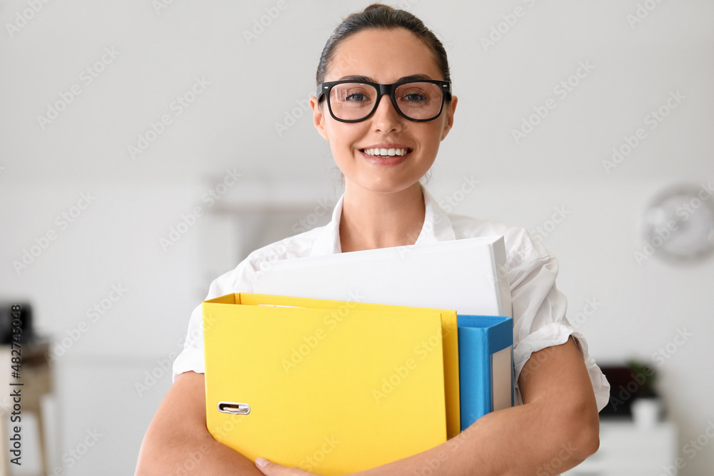Young woman working with documents in office Young woman working with documents in office