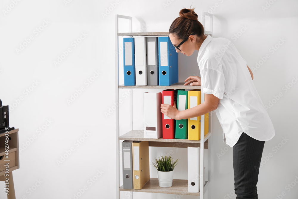 Young woman working with documents in office Young woman working with documents in office