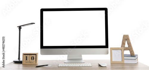 Wooden table with modern computer, decor and stationery on white background