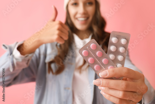 Young smiling woman showing...