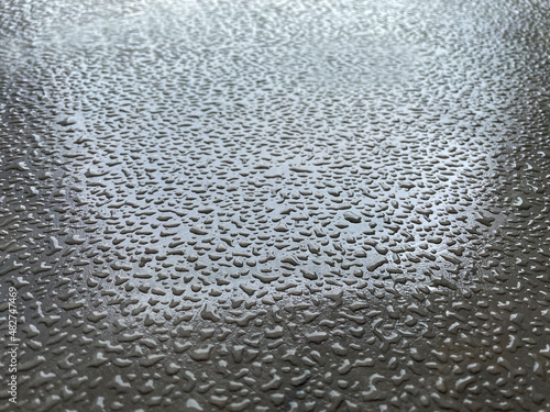 Water droplets on grey floor