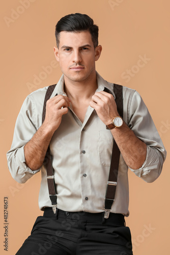 Fashionable gentleman sitti...
