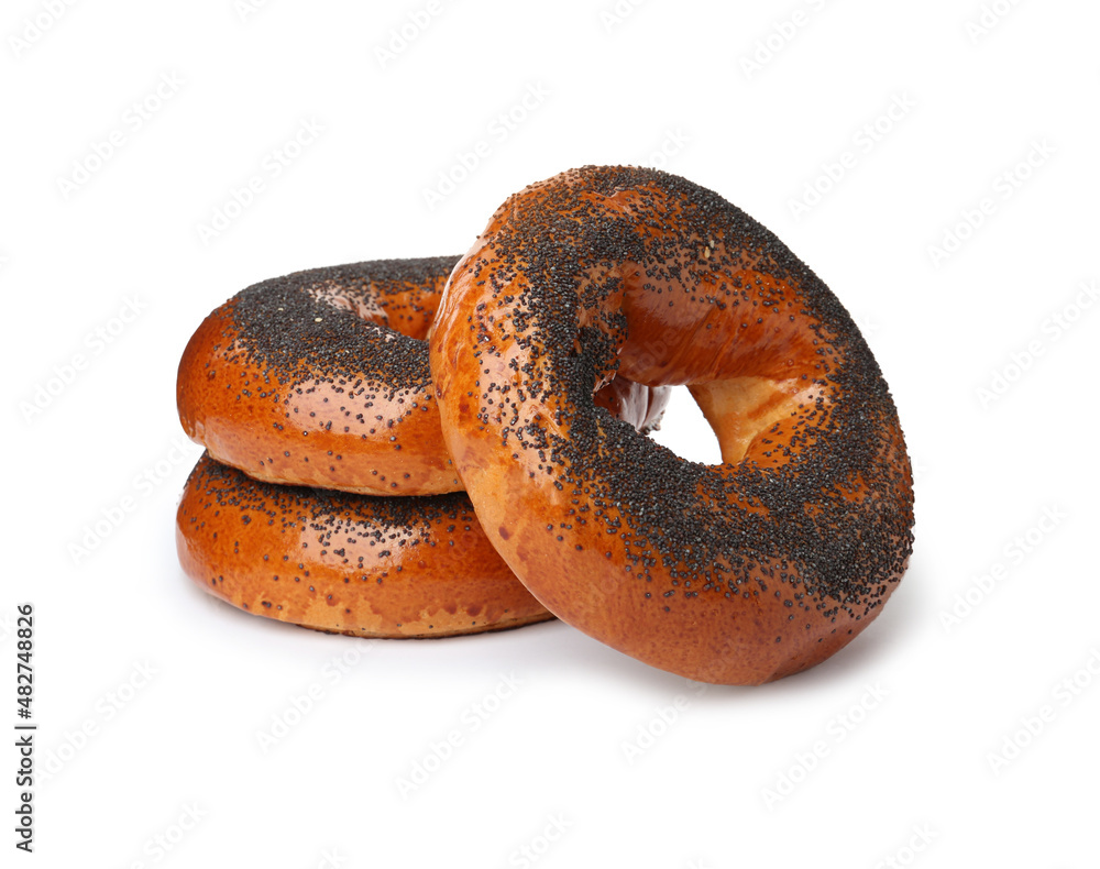 Delicious fresh bagels with poppy seeds isolated on white Delicious fresh bagels with poppy seeds isolated on white