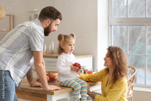 Happy young family in kitchen at home