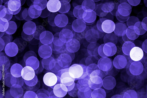 Colored blurred bokeh. abstract background of included festive garlands. colorful blur light bulbs