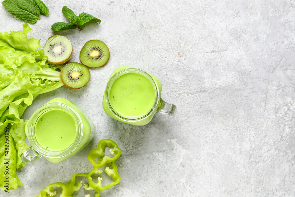 Mason jars of healthy green juice on light background Mason jars of healthy green juice on light background