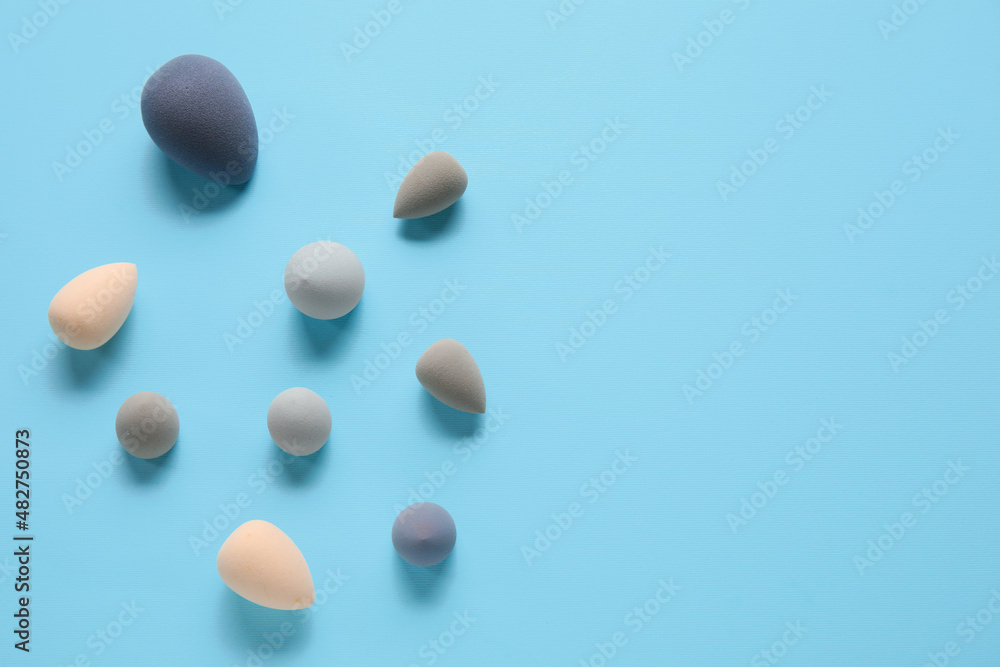 Different makeup sponges on blue background Different makeup sponges on blue background