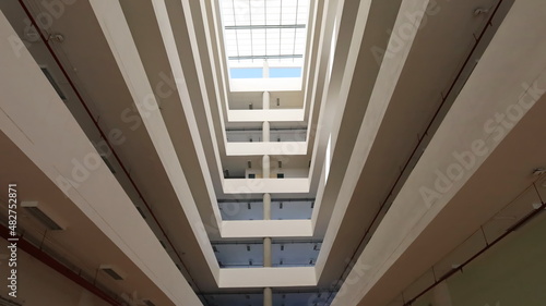 Open atrium in a modern building. An empty space in the middle of the building for sunlight and ventilation in the bottom view. Selective focus