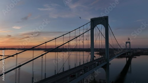 flying around Bronx Whitestone Bridge revealing sunset over NYC photo