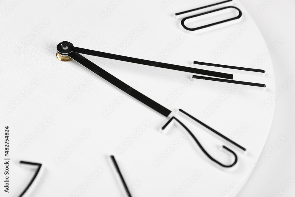 Stylish analog clock on white background, closeup. New Year countdown Stylish analog clock on white background, closeup. New Year countdown