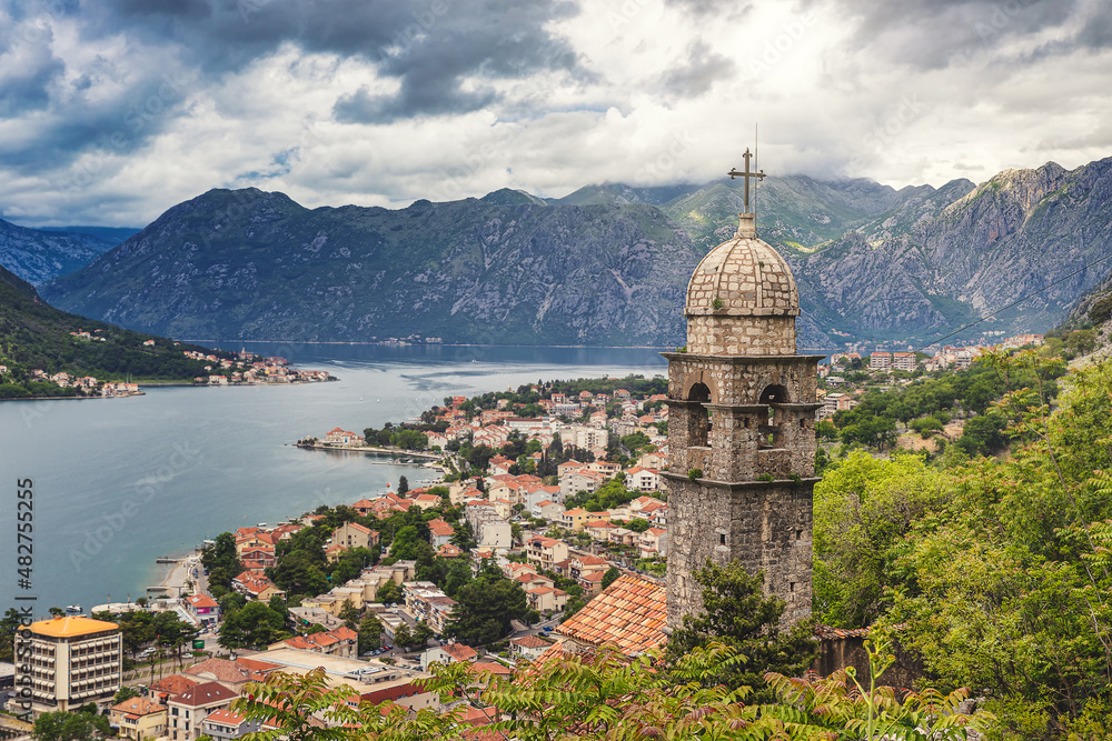 Famous view of the bell tower and Kotor old town, surrounded by mountains and waters of Kotor bay