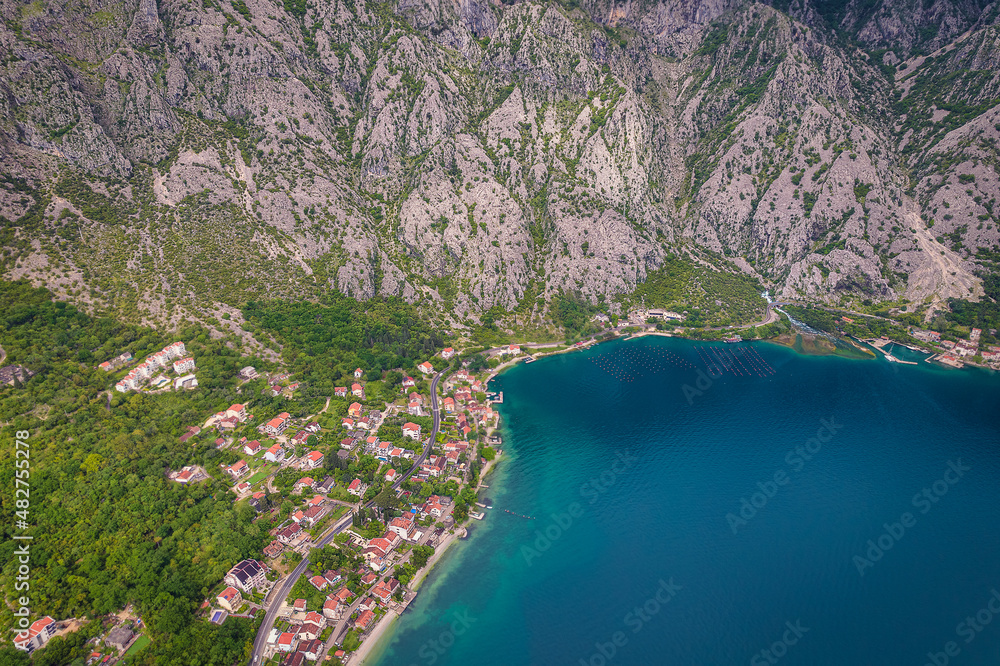 Obraz premium Aerial view of huge mountains and small towns of Kotor Bay, Montenegro