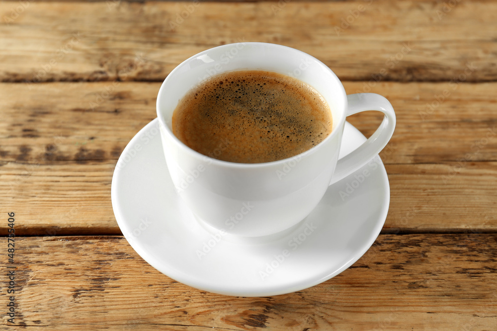 Cup of tasty coffee on wooden table Cup of tasty coffee on wooden table