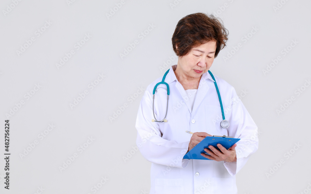 Elegant senior female doctor on physician gown confidently standing as hospitally health expert for disease treatment at clinic. Elegant senior female doctor on physician gown confidently standing as hospitally health expert for disease treatment at clinic.