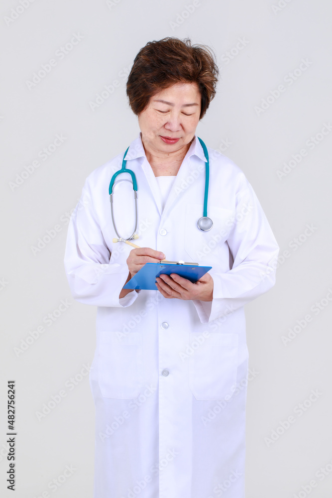 Elegant senior female doctor on physician gown confidently standing as hospitally health expert for disease treatment at clinic. Elegant senior female doctor on physician gown confidently standing as hospitally health expert for disease treatment at clinic.