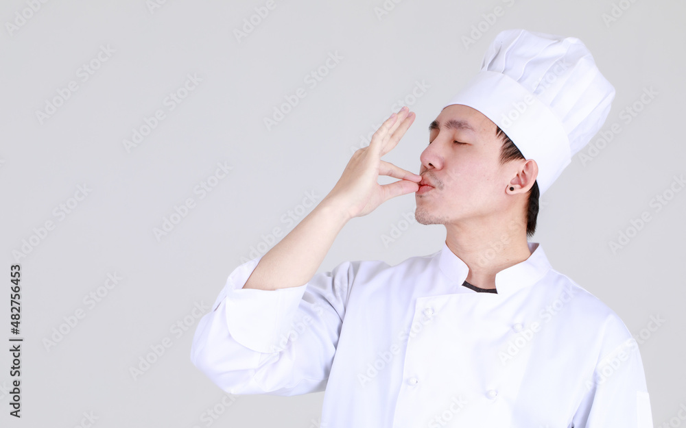 Experienced and smart chinese chef on elegant cooking uniform smile and standing confidently at kitchen with arm crossed as qualified expert of cuisine for luxurious dining Experienced and smart chinese chef on elegant cooking uniform smile and standing confidently at kitchen with arm crossed as qualified expert of cuisine for luxurious dining