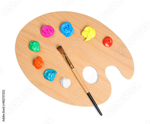 Palette with paints and brush on white background, top view. Artist equipment