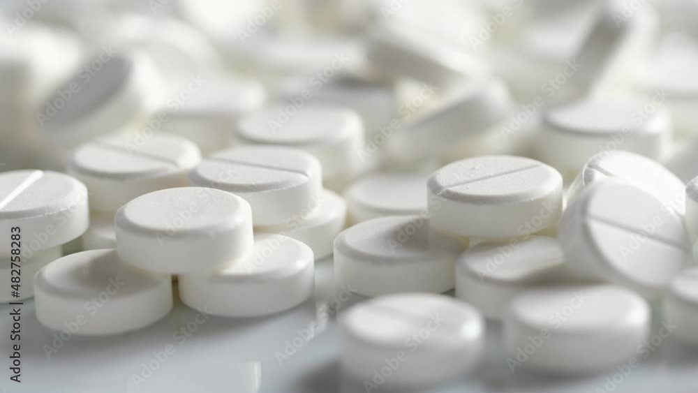 White medical pills rotating closeup. Pills and drugs. Pharmaceutical Industry. The medicine concept. 4K White medical pills rotating closeup. Pills and drugs. Pharmaceutical Industry. The medicine concept. 4K