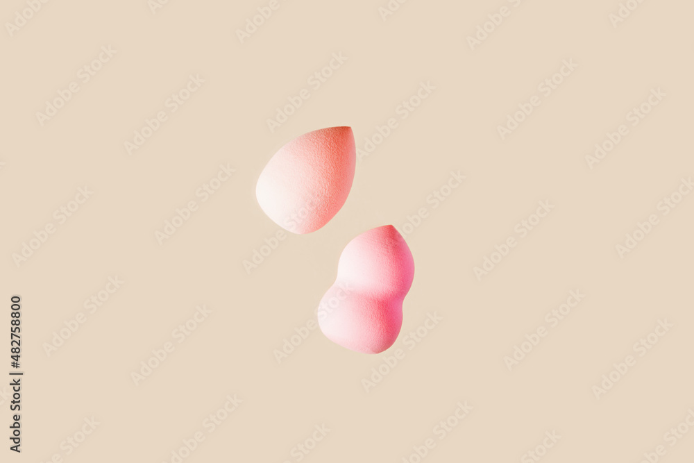 Beauty blender sponge pink beige colored. Soft make up cosmetic sponge, brush for face skin, facial applicator. Backgrounds for salon fashion beauty makeup. Neutral pastel color. Beauty blender sponge pink beige colored. Soft make up cosmetic sponge, brush for face skin, facial applicator. Backgrounds for salon fashion beauty makeup. Neutral pastel color.