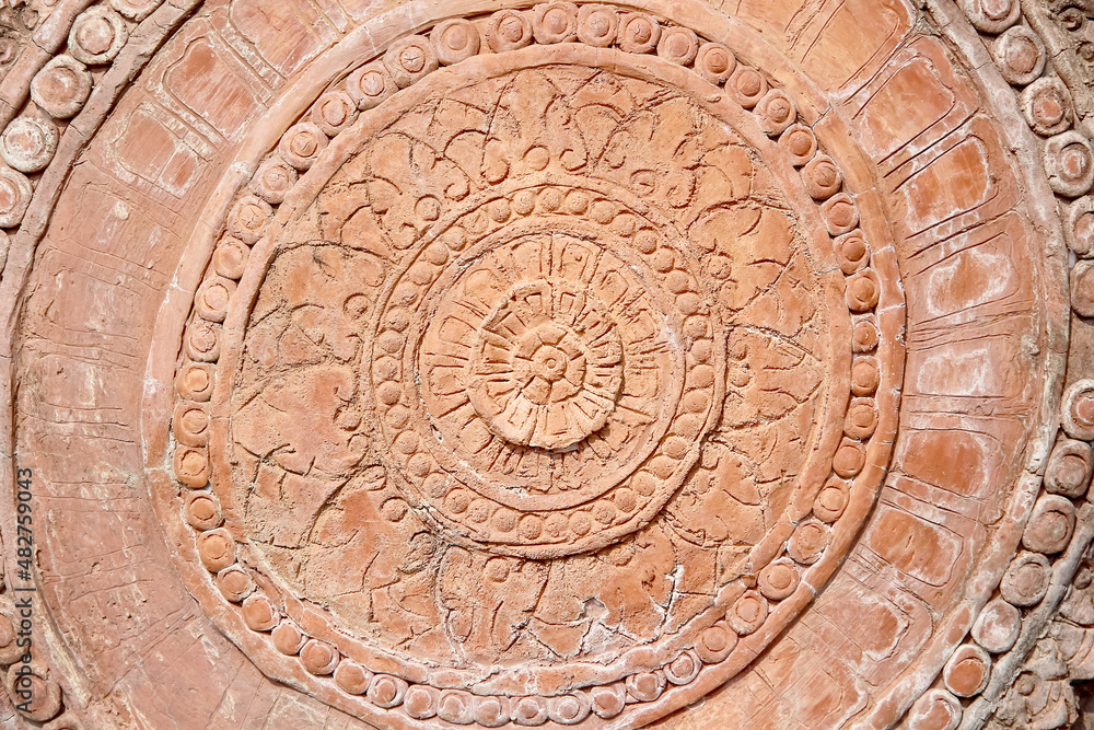 Engraving on stone wall background with flower circle patterns