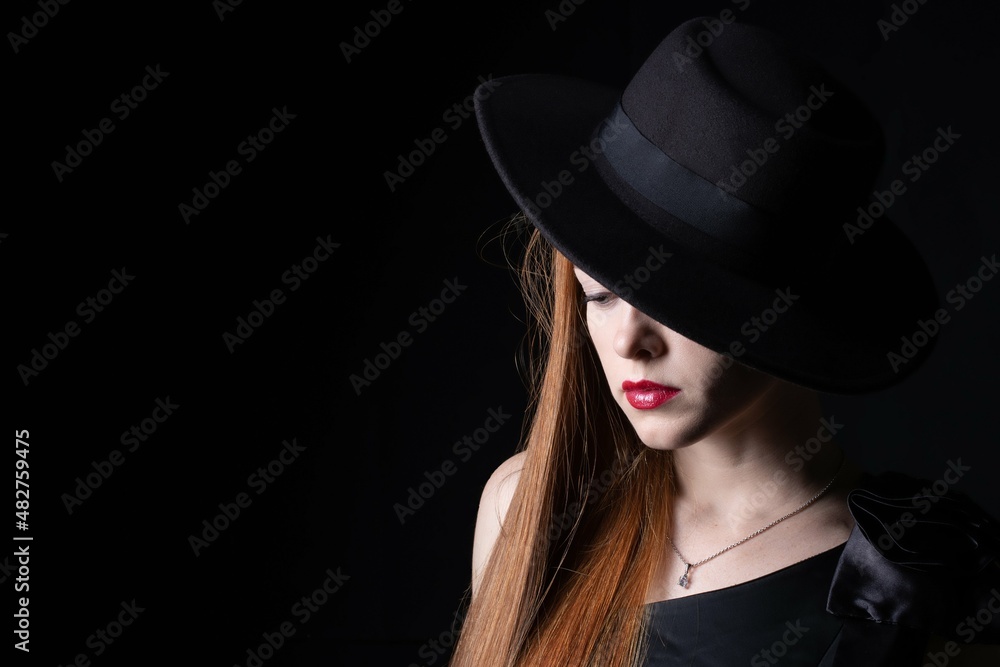 portrait of a girl with long hair, wearing a hat, on a black background portrait of a girl with long hair, wearing a hat, on a black background