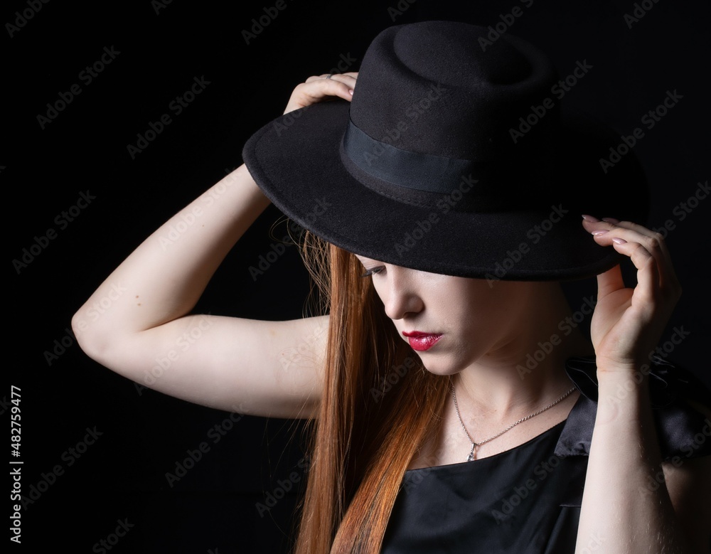 portrait of a girl with long hair, wearing a hat, on a black background portrait of a girl with long hair, wearing a hat, on a black background