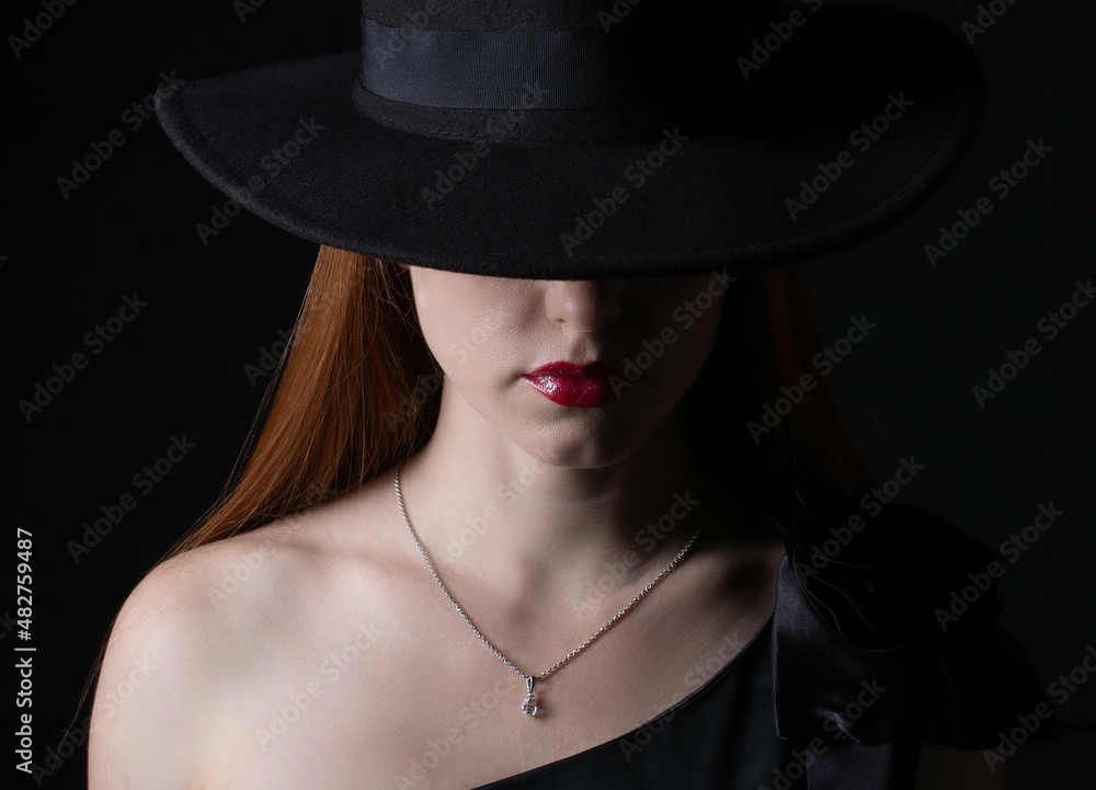 portrait of a girl with long hair, wearing a hat, on a black background portrait of a girl with long hair, wearing a hat, on a black background