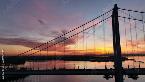 flying right alongside Bronx Whitestone Bridge sunset over NYC in bkrd photo