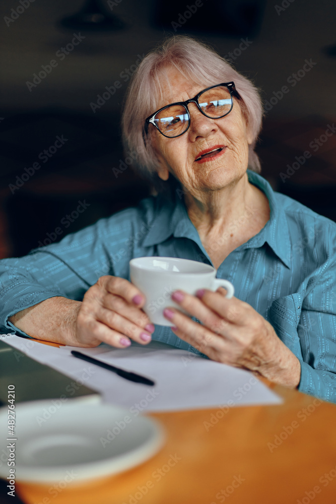 Senior woman documents work sheet of paper and pen Freelancer works unaltered Senior woman documents work sheet of paper and pen Freelancer works unaltered