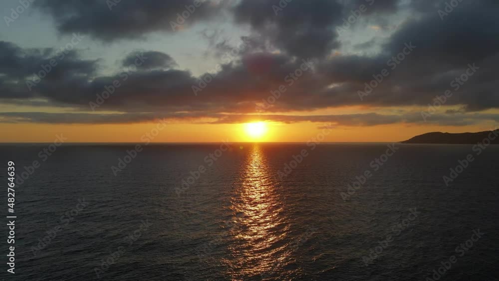 A beautiful, dramatic seascape sunrise over calm water. Stunning cloudscape ocean horizon. A beautiful, dramatic seascape sunrise over calm water. Stunning cloudscape ocean horizon.