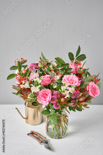 Finished flower arrangement in a vase for home. Flowers bunch, set for interior. Fresh cut flowers for decoration home. European floral shop. Delivery fresh cut flower.