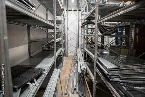 Assembly of a warehouse in a clothing store with stacked iron shelves