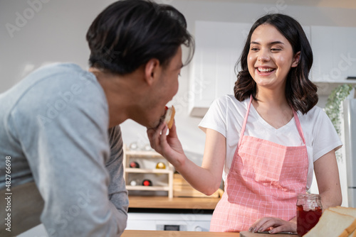 Asian young new marriage couple spend time together in kitchen at home