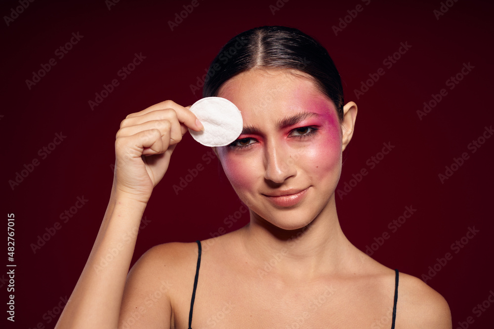 Sexy brunette woman pink face makeup posing attractive look skin care cropped view unaltered Sexy brunette woman pink face makeup posing attractive look skin care cropped view unaltered