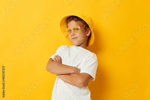 boy in yellow hat with glasses childrens fashion yellow background