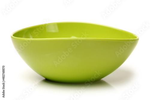 Bright green plastic empty bowl on a white background 