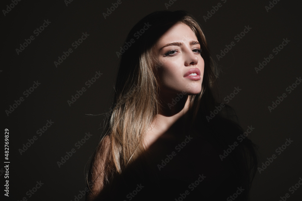Portrait of beautiful woman model looking seductive and sensual. Beauty face with dramatic studio light isolated on black. Sensual girl. Portrait of beautiful woman model looking seductive and sensual. Beauty face with dramatic studio light isolated on black. Sensual girl.