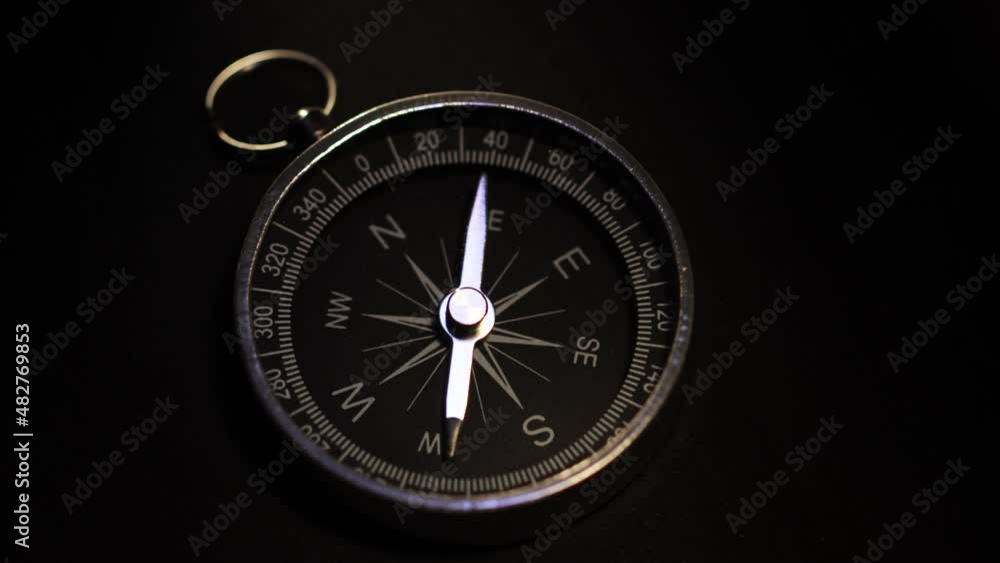 A shot of a compass on a black background A shot of a compass on a black background
