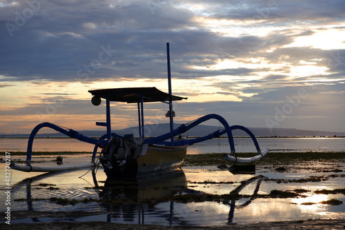 outrigger boat on beach before sunrise