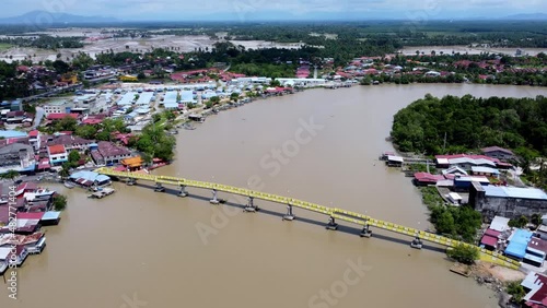 Aerial view fly over yellow pedestrian bridge at Kuala Kurau town photo