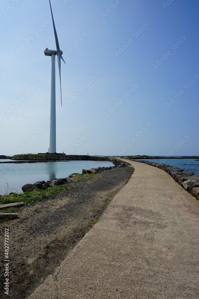 seaside walkway and wind power plant